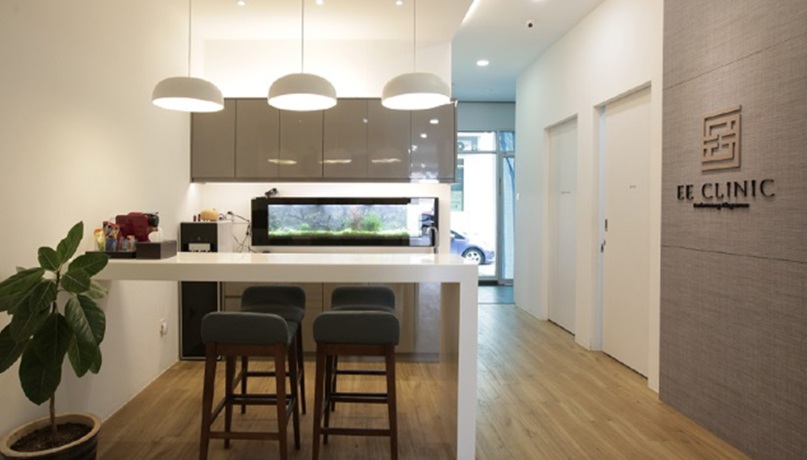 Clinic lounge with pendant lights, seating, aquarium and EE Clinic wall sign