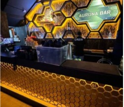 Entertainment venue bar counter with illuminated honeycomb panels