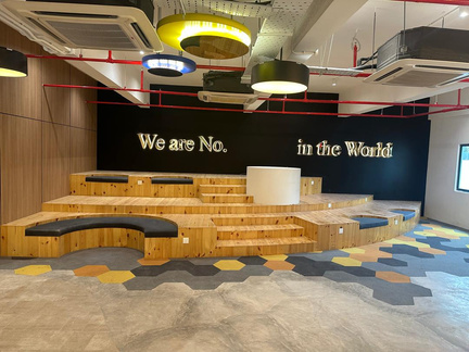 Completed commercial breakout space with tiered seating and feature lighting