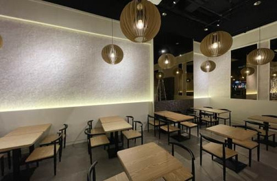 Restaurant dining room with pendant lighting and fitted seating