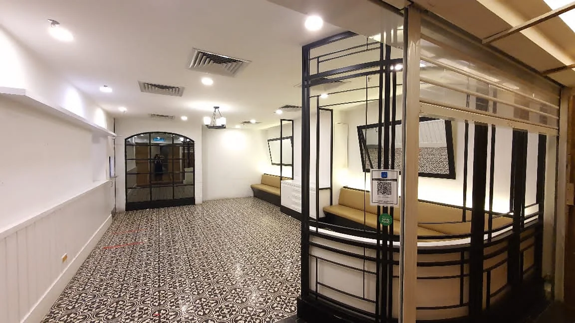 Completed Taiwanese restaurant interior with patterned flooring, fitted seating and black-framed screens