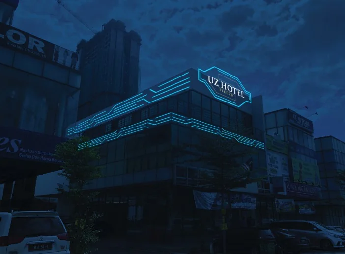 Capsule hotel exterior with blue illuminated facade lighting at night
